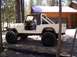 1982 Jeep CJ7 - This 1982 Jeep CJ7 is captured in a side profile, its black soft top and prominent roll bar.