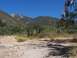 1990 Ford Bronco - A scenic view of a mountain range covered in trees and brush, with a dry, dusty foreground.