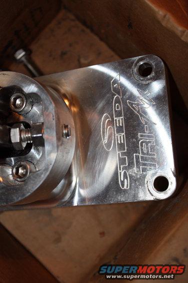 Close-up of a Steeda Tri-Ax shifter part with mounting holes