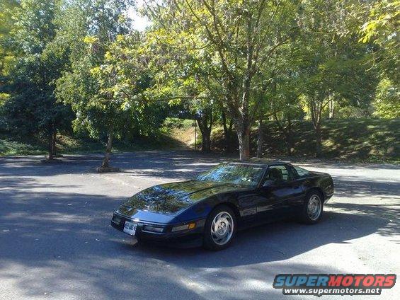 Black Chevrolet Corvette C4 parked outside on a sunny day
