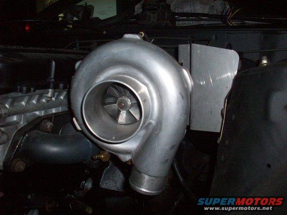 Turbocharger mounted in engine bay, likely for performance upgrade