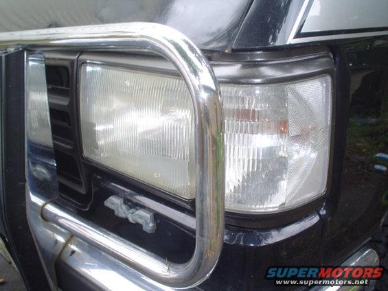 Black Ford Bronco front end with chrome bull bar, showing headlights and a "4x4" badge