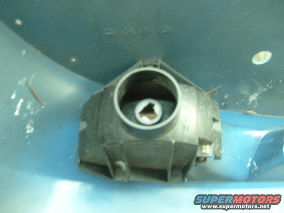 Close-up of a vehicle headlight housing with a circular opening