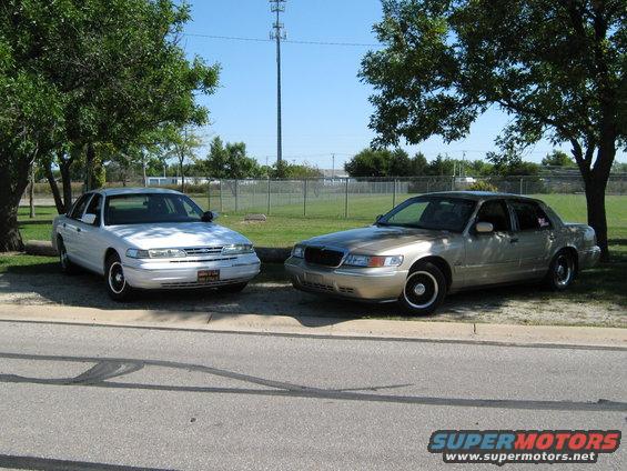 Gold 2000 Mercury Grand Marquis parked next to a white sedan