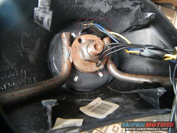 1.jpg TURN SIGNAL SWITCH / TILT WHEEL
My turn signal switch/tilt wheel broke a few months ago.  The lever was real loose, I'd push back for the tilt and I could feel the play as the lever hit the tilt bar and would give way...the switch inside was loose or broke.  So the tilt wheel was stuck in my "drive" position - great for getting in/out - and the turn signal lever would not snap back to the off position after completing a turn.  After banging my knees a few times, it's time to take a look.  Bottom side of wheel - remove the two screws and take off the front of the steering wheel.  It will look like the pic above.  Two wires to remove first.  The single black line is the ground, and it's in the hole with a spring clip.  Squeeze and pull.  The wires at top are the cruise control.  It's really one long plug, so grab at either side and start to tug off.  