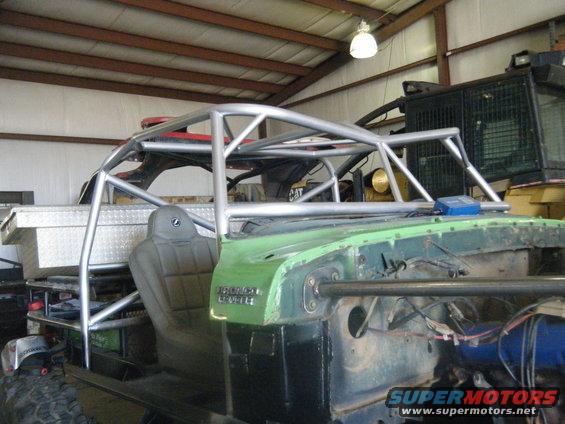 off-road buggy roll cage over green body panel and seat