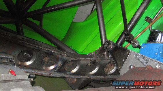 Custom suspension linkage and frame reinforcement with bright green body paneling above