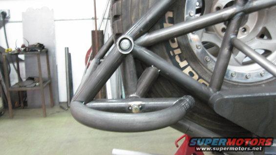 Custom roll cage tubing welded around a large off-road tire