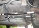1999 Ford Taurus - The photo shows the underside of a vehicle, focusing on the rear suspension and fuel tank components.