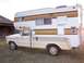 1979 Ford F-250 - This 1979 Ford F-250 pickup truck is equipped with a camper shell, seen from the side.