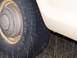 1979 Ford F-250 - Close-up of a 1979 Ford F-250's side, showing the tire and fender with visible rust spots.