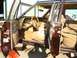 1984 Ford LTD - The interior of a brown station wagon is shown with tan upholstery and wood paneling details.