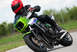 2001 Kawasaki KZ1000-A1 - Rider takes a corner on a motorcycle, leaning significantly into the turn.