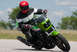 2001 Kawasaki KZ1000-A1 - A rider in full gear takes a corner on a green motorcycle, with "SUPERMOTORS.NET" visible at the bottom.