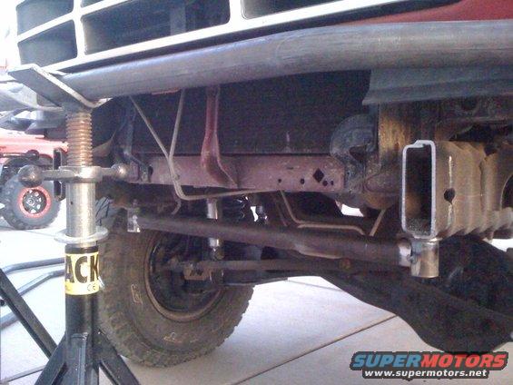 1989 Ford Bronco front suspension with jack stand, showing frame and steering components