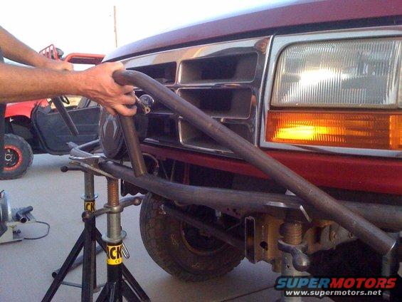 Red SUV front end with custom roll cage and grille