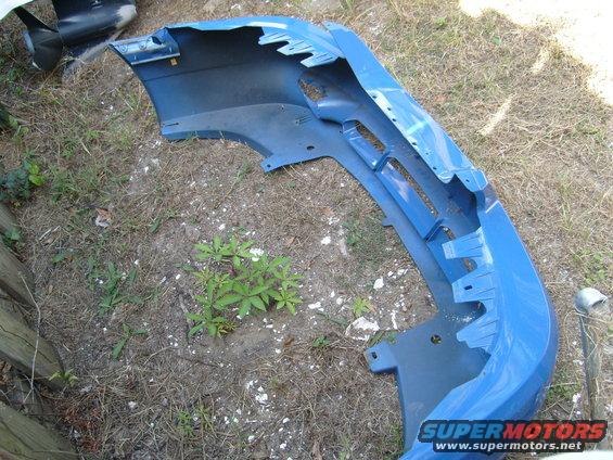 blue car bumper lying on the ground