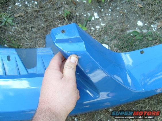 Blue bumper part held by hand
