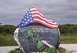1987 Ford Bronco - A stone memorial features an American flag, painted soldiers, and names of fallen service members.