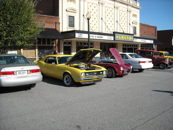 Yellow classic car, front view, hood open