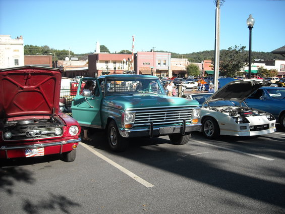 Teal pickup truck with chrome grille and horizontal headlights