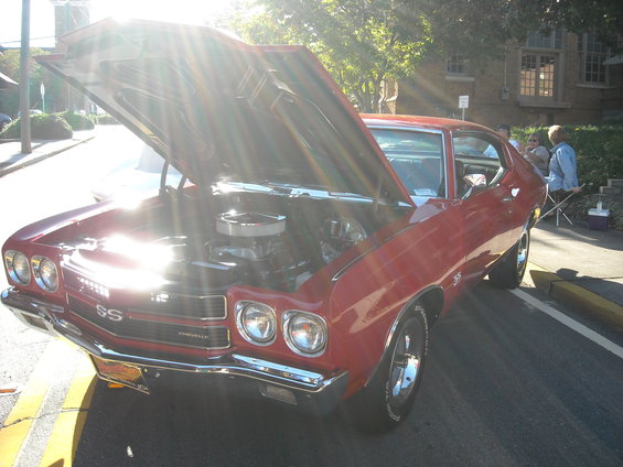 Red 1970 Chevrolet Chevelle SS with hood open, showing engine