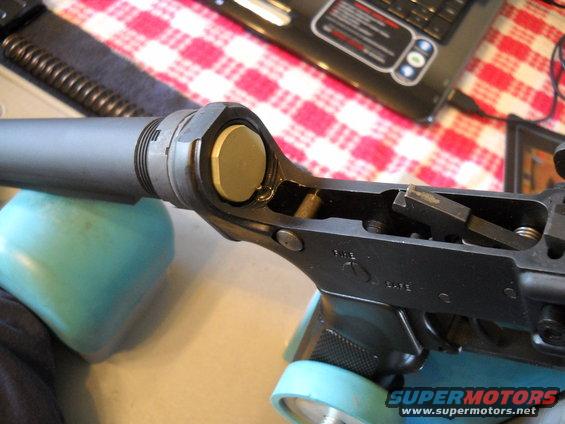 AR-15 lower receiver assembly with a brass buffer retaining pin