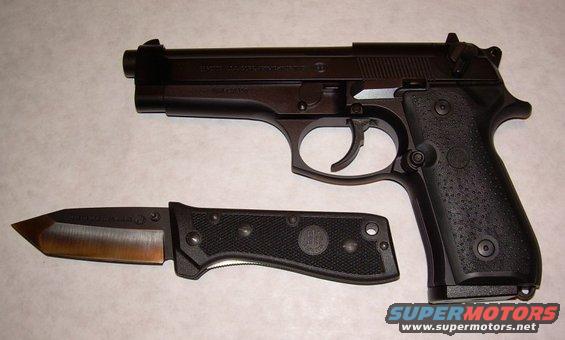 Beretta 92FS pistol and a black folding knife with a bronze blade