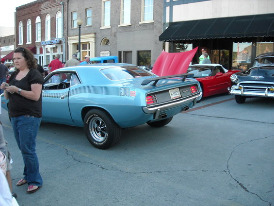 Light blue 1970 Plymouth Barracuda with a spoiler and 'CUDA' graphics
