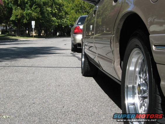 Tan 2000 Mercury Grand Marquis side view with chrome wheels