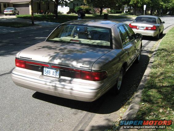 Rear view of a 2000 Mercury Grand Marquis parked on street, another identical car behind it