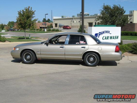 Tan 2000 Mercury Grand Marquis sedan, side view