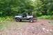 1988 Chevrolet Blazer - This modified SUV is parked on a dirt path surrounded by trees and foliage.
