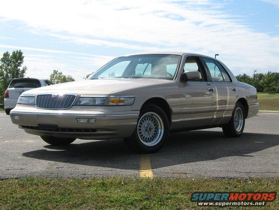 Tan 2000 Mercury Grand Marquis parked on asphalt with another vehicle in the background