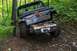 1988 Chevrolet Blazer - A Jeep Wrangler navigates a challenging off-road trail, its rear axle high off the ground.