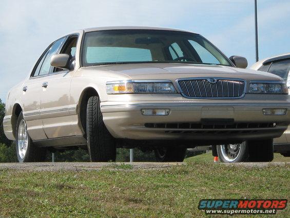 Tan 2000 Mercury Grand Marquis, front view, chrome grille, slight angle