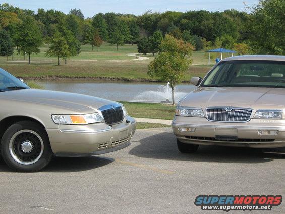 Two tan 2000 Mercury Grand Marquis sedans parked near a pond