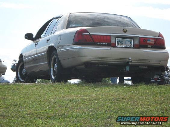 Rear view of a tan 2000 Mercury Grand Marquis with a license plate WYR 096