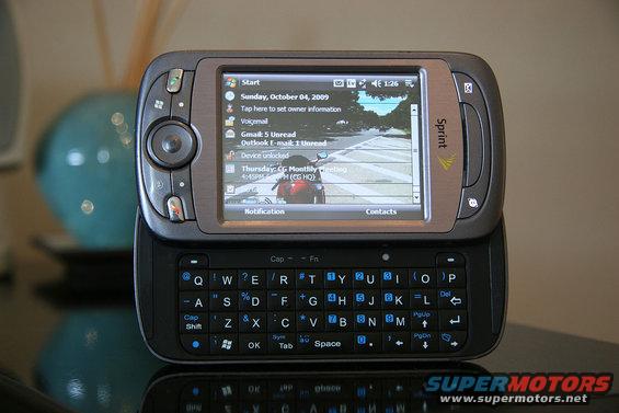 Sprint mobile phone with slide-out QWERTY keyboard and touchscreen displaying a calendar and email notifications