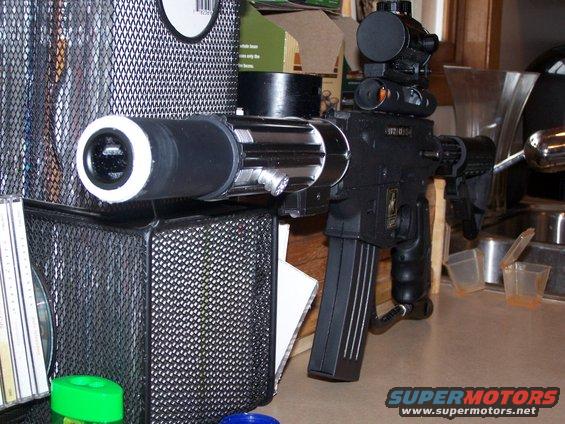 Modified rifle with scope, silencer, and magazine