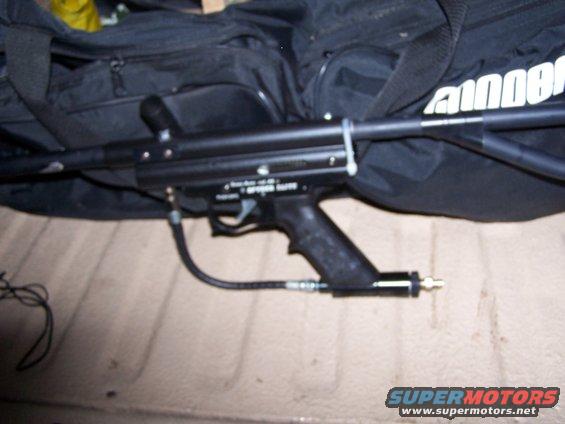 Paintball gun resting on a black bag