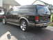 2000 Ford Excursion - Rear view of a black 2000 Ford Excursion Limited with chrome wheels.