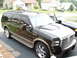 2000 Ford Excursion - A black 2000 Ford Excursion is parked in a driveway next to another vehicle.