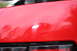 2004 Ford Mustang - Close-up of red car paint with visible swirl marks, and a watermark at the bottom.