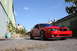 2004 Ford Mustang - This red 2004 Ford Mustang features a distinctive black stripe on its hood and is captured in a three-quarter front view.