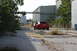 2004 Ford Mustang - Red 2004 Ford Mustang coupe seen from the rear on an abandoned industrial lot.