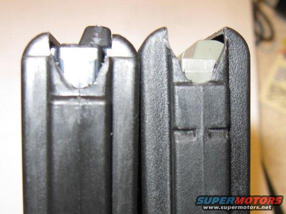 Close-up of two black gun magazines, one on the left and one on the right, showing their feed lips