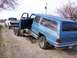 1900 Ford C-350 (Centurion Conversions) - Blue SUV loaded onto a trailer, with a white Dodge pickup truck visible behind it.