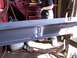 1900 Ford C-350 (Centurion Conversions) - Steel beam undergoing welding repairs in a workshop environment.