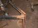 1900 Ford C-350 (Centurion Conversions) - Close-up of a trailer frame, showing a jack and chain, with a hammer on the floor.
